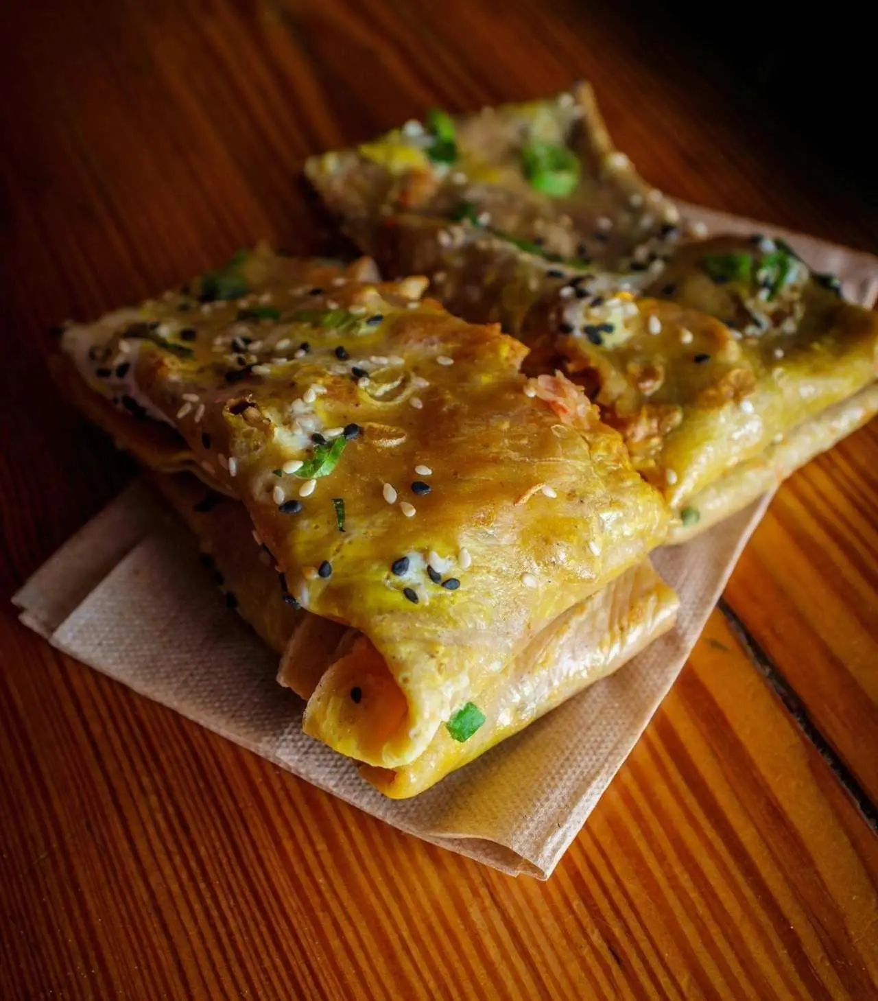 Jianbing or Chinese crape on a napkin on wooden table